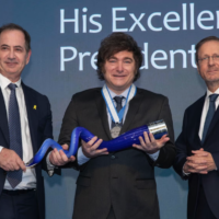 President of Argentina Javier Milei poses holding the Genesis Prize with Stan Polovets and Israeli President Isaac Herzog during the Genesis Prize ceremony at The Museum of Tolerance on June 12, 2025 in Jerusalem, Israel. (Lior Mizrahi/Getty Images for Genesis Prize Foundation via JTA)